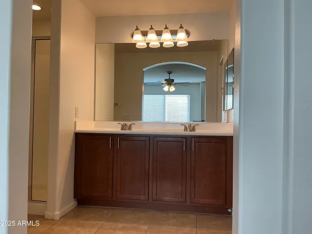 a bathroom with a double vanity sink and a mirror