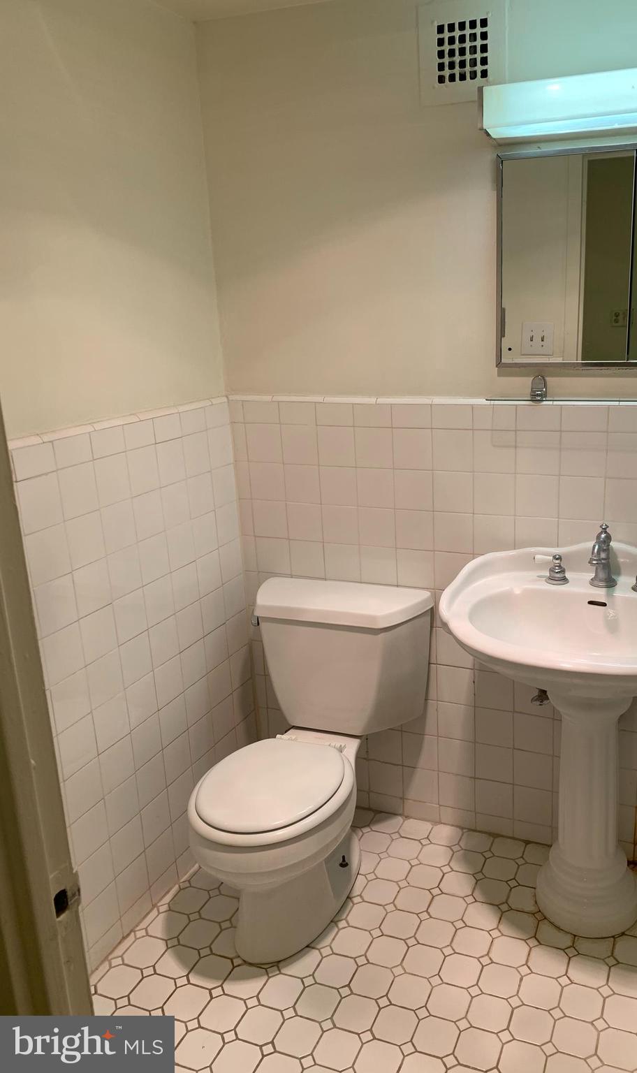 224-30 West Rittenhouse Square, Unit 2004 Philadelphia, PA 19103 - Photo 7 of 18 a white toilet sitting next to a bathroom sink