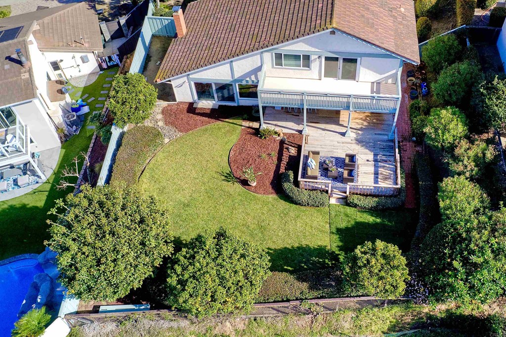 an aerial view of a house with swimming pool garden and patio