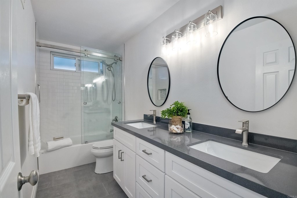 735 Santa Paula Solana Beach, CA 92075 - Photo 26 of 61 a bathroom with a granite countertop toilet a sink a mirror and a shower