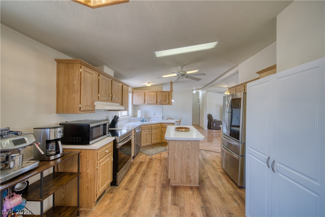 2931 Rio Rancho Drive, Unit 4 Pahrump, NV 89048 - Photo 6 of 21 A well-lit culinary space features abundant cabinetry, durable flooring, and modern stainless steel appliances.