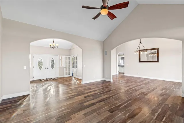 a kitchen with stainless steel appliances granite countertop a sink a stove and a wooden floors