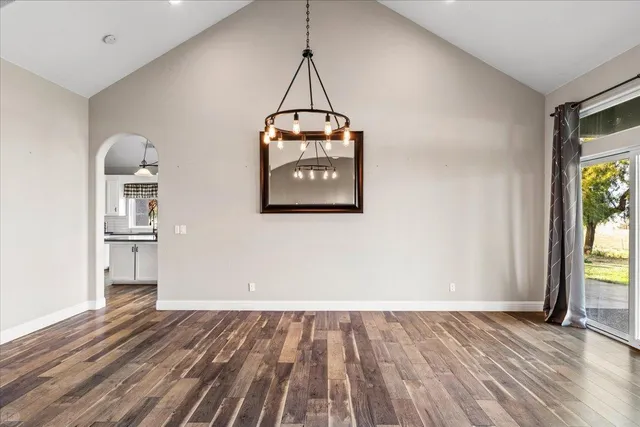 a kitchen with a wooden floor and white cabinets
