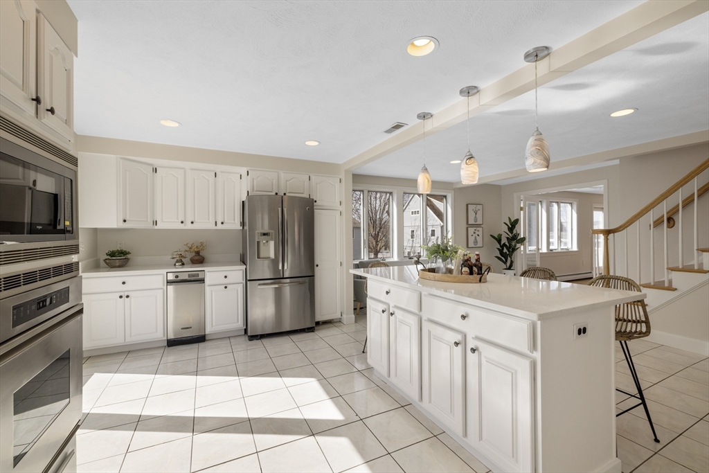 61 School Street Lexington, MA 02421 - Photo 12 of 42 a kitchen with stainless steel appliances kitchen island granite countertop a sink and cabinets