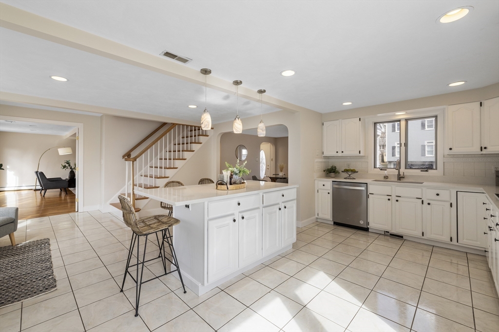 61 School Street Lexington, MA 02421 - Photo 13 of 42 a large white kitchen with cabinets and chairs