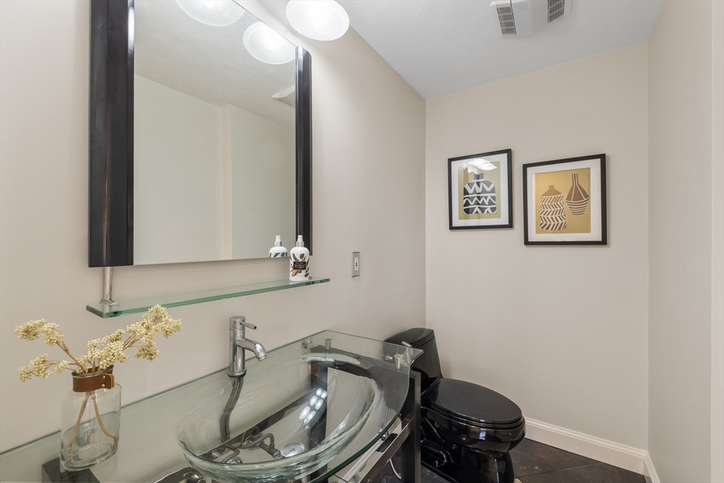 61 School Street Lexington, MA 02421 - Photo 18 of 42 a bathroom with a sink and a mirror