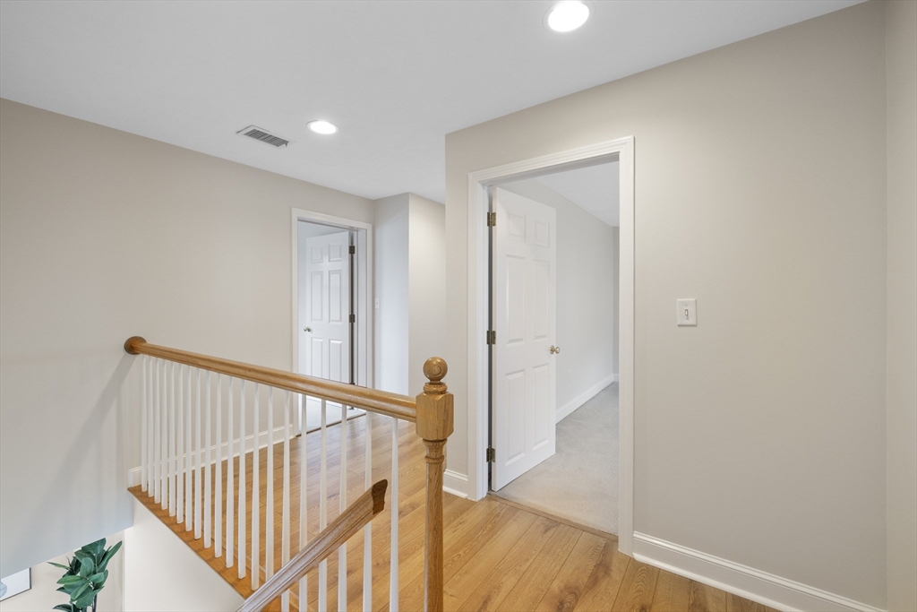 61 School Street Lexington, MA 02421 - Photo 20 of 42 a view of staircase with railing and white walls