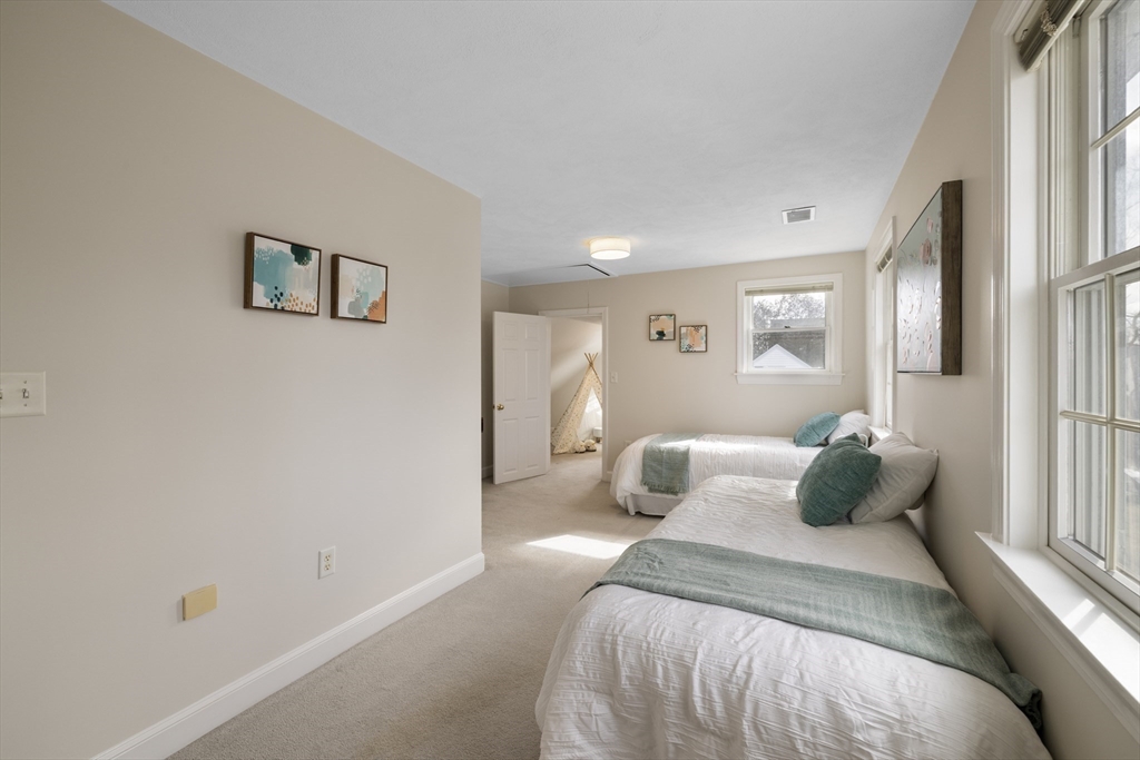 61 School Street Lexington, MA 02421 - Photo 21 of 42 a bedroom with a bed and a window