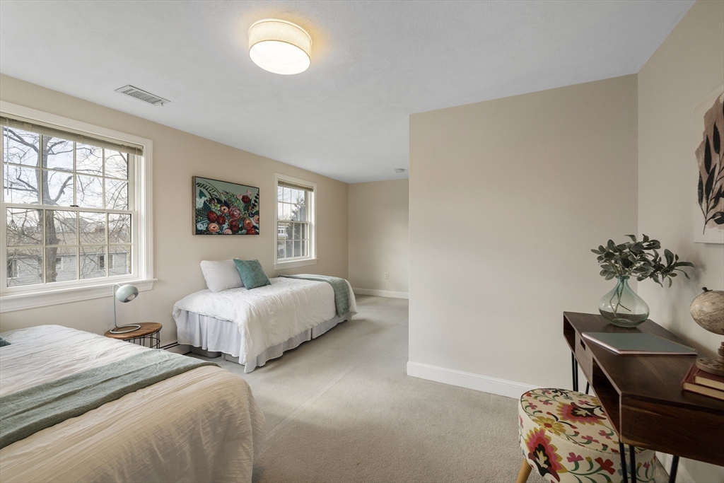 61 School Street Lexington, MA 02421 - Photo 22 of 42 a bedroom with a bed and a window
