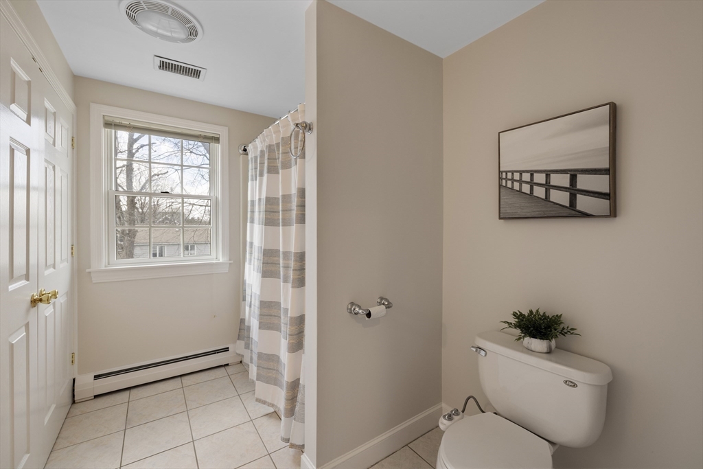 61 School Street Lexington, MA 02421 - Photo 24 of 42 a bathroom with a toilet a sink and a window