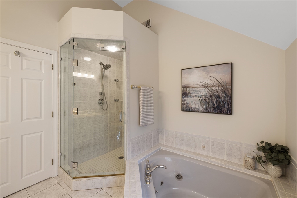 61 School Street Lexington, MA 02421 - Photo 30 of 42 a bathroom with a shower and a bath tub