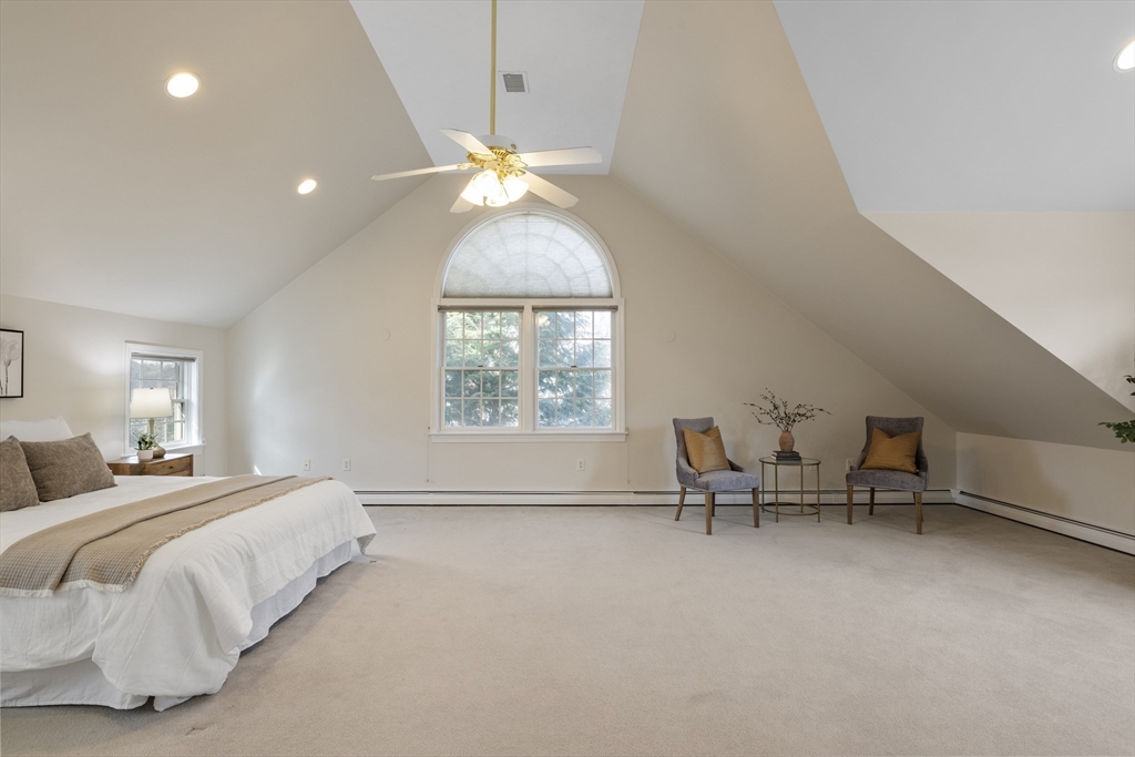 61 School Street Lexington, MA 02421 - Photo 32 of 42 a bedroom with a bed and a chandelier