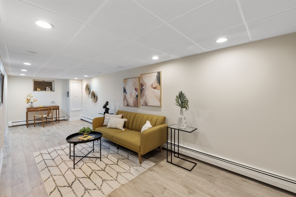 61 School Street Lexington, MA 02421 - Photo 35 of 42 a living room with furniture a couch and a potted plant