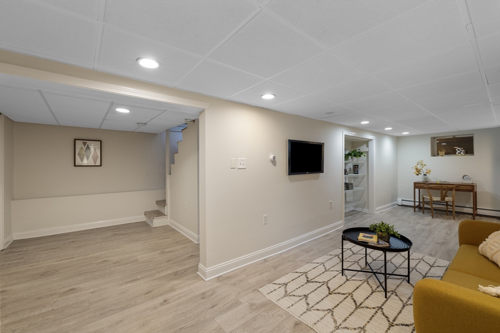 61 School Street Lexington, MA 02421 - Photo 36 of 42 a living room with furniture and a flat screen tv
