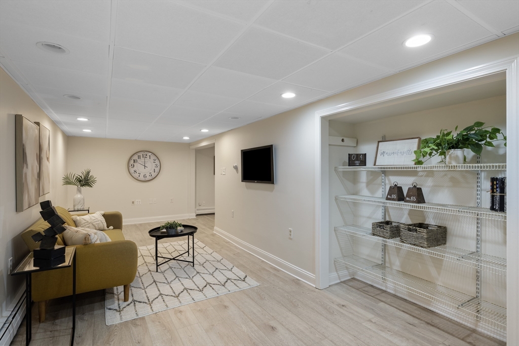 61 School Street Lexington, MA 02421 - Photo 37 of 42 a living room with furniture and a flat screen tv