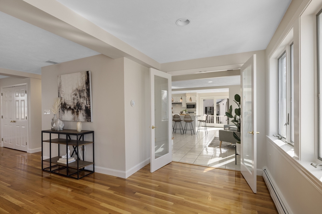 61 School Street Lexington, MA 02421 - Photo 9 of 42 a view of a livingroom with wooden floor and a dining table