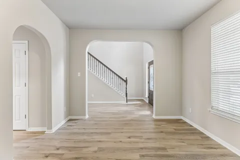 a view of a livingroom with wooden floor and window
