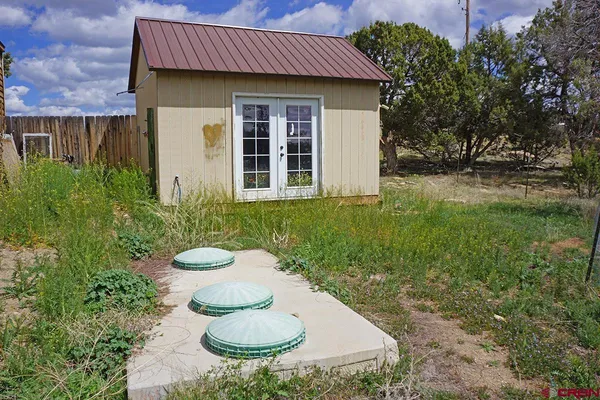 a view of a house with pool and garden
