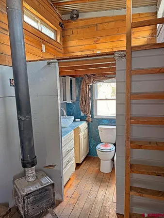 a bathroom with a toilet a sink and a window