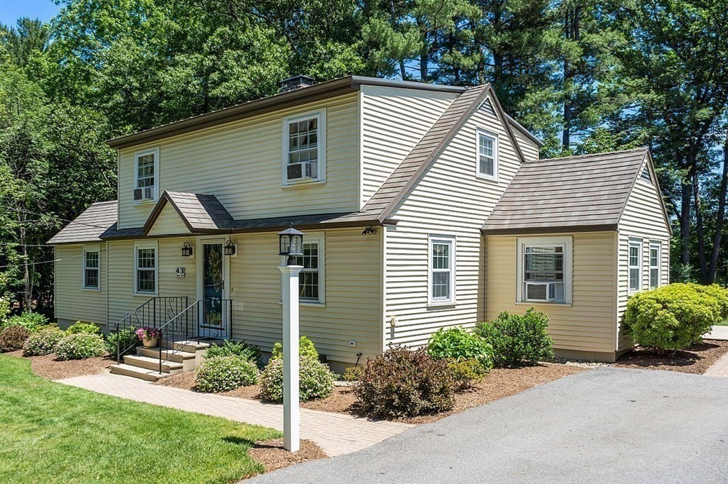 43 Sylvan Road Lancaster, MA 01523 - Photo 1 of 26 a view of a house with a yard and plants