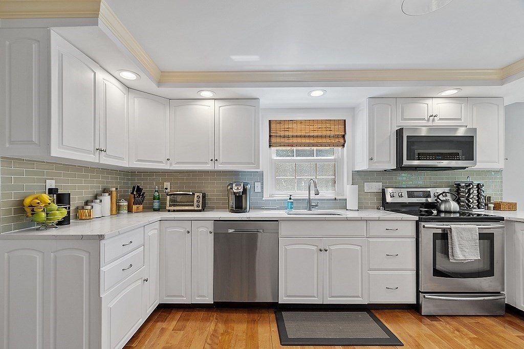 43 Sylvan Road Lancaster, MA 01523 - Photo 2 of 26 a kitchen with white cabinets and appliances
