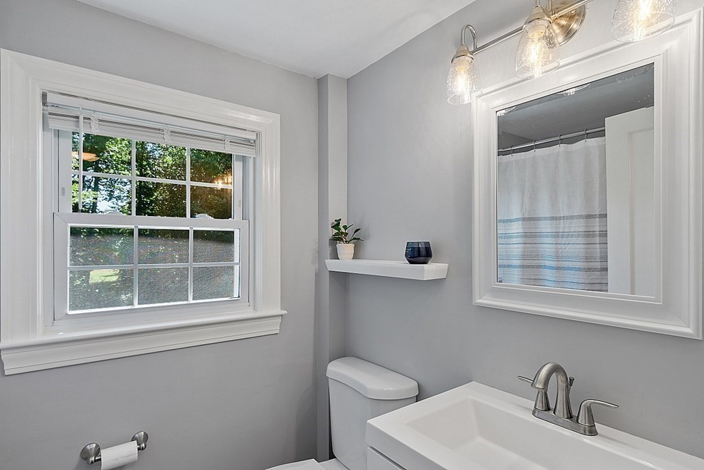 43 Sylvan Road Lancaster, MA 01523 - Photo 21 of 26 a bathroom with a sink a toilet and a window