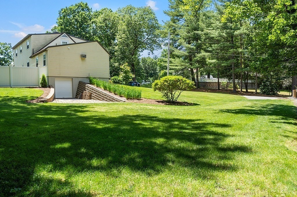 43 Sylvan Road Lancaster, MA 01523 - Photo 24 of 26 a view of a playground with a garden and trees