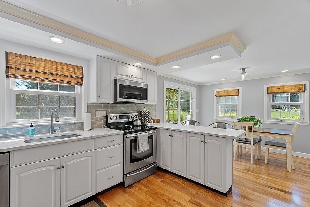 43 Sylvan Road Lancaster, MA 01523 - Photo 3 of 26 a kitchen with a sink stove cabinets and wooden floor