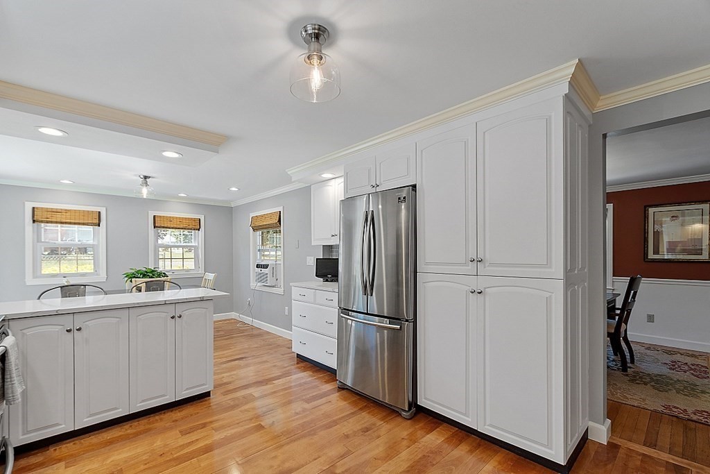 43 Sylvan Road Lancaster, MA 01523 - Photo 4 of 26 a kitchen with a refrigerator a sink and dishwasher with wooden floor