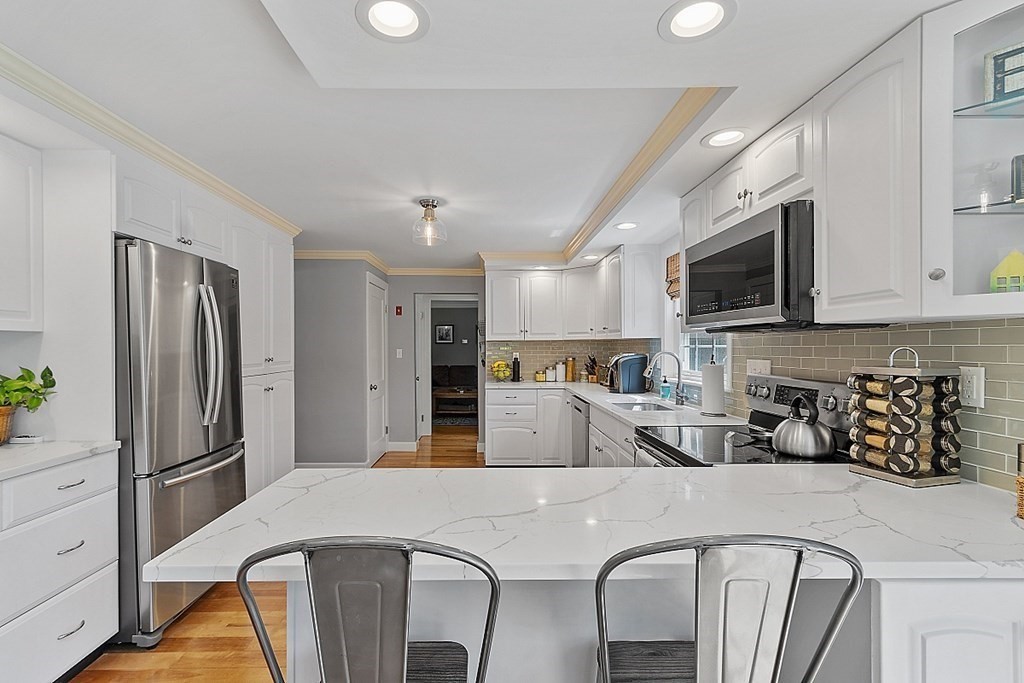 43 Sylvan Road Lancaster, MA 01523 - Photo 5 of 26 a kitchen with stainless steel appliances granite countertop a refrigerator a stove a sink a microwave and a refrigerator