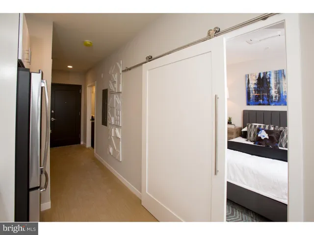 a bedroom with a bed and a lamp on table