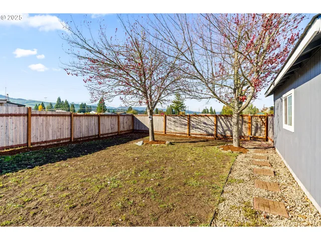 a backyard of a house with wooden fence