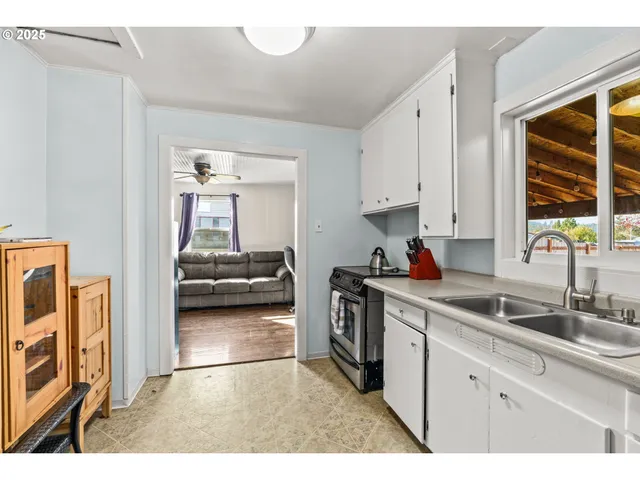 a kitchen with a sink stove and cabinets