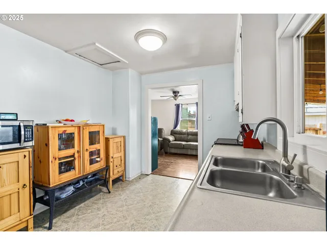 a kitchen with stainless steel appliances kitchen island granite countertop a sink and cabinets