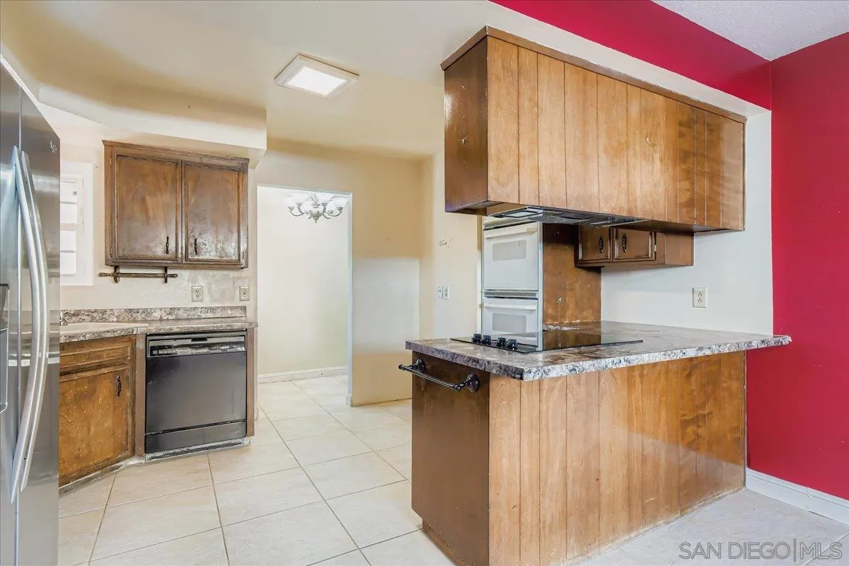 3245 Valley Street Carlsbad, CA 92008 - Photo 13 of 30 a kitchen with kitchen island granite countertop a stove and a sink