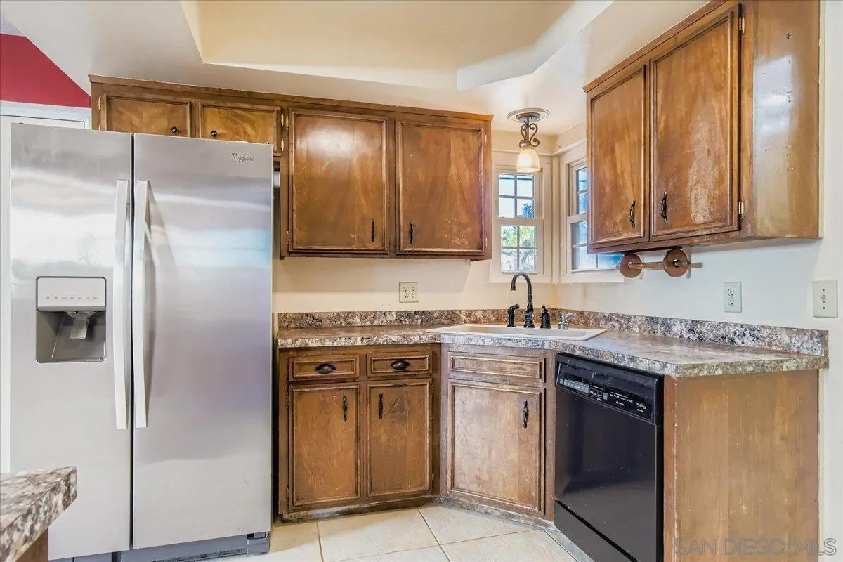 3245 Valley Street Carlsbad, CA 92008 - Photo 14 of 30 a kitchen with stainless steel appliances granite countertop a stove a refrigerator and a sink