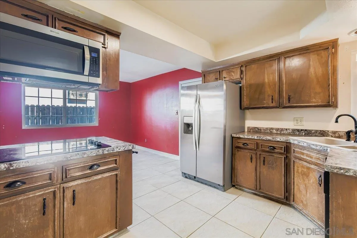 3245 Valley Street Carlsbad, CA 92008 - Photo 15 of 30 a kitchen with stainless steel appliances granite countertop a refrigerator stove and sink