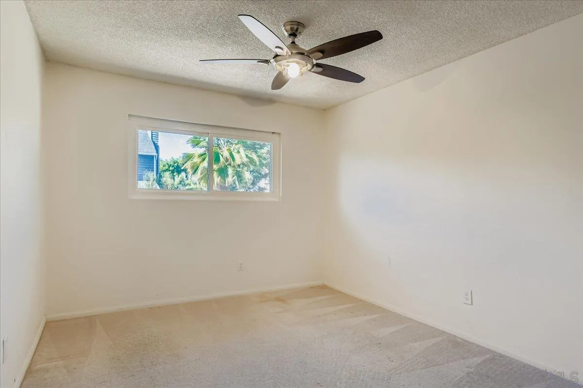 3245 Valley Street Carlsbad, CA 92008 - Photo 17 of 30 an empty room with windows and ceiling fan