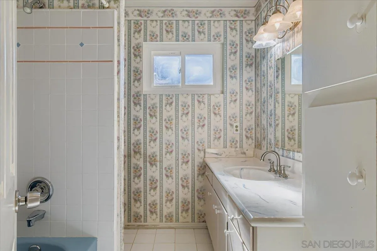3245 Valley Street Carlsbad, CA 92008 - Photo 20 of 30 a bathroom with a granite countertop sink a mirror and shower