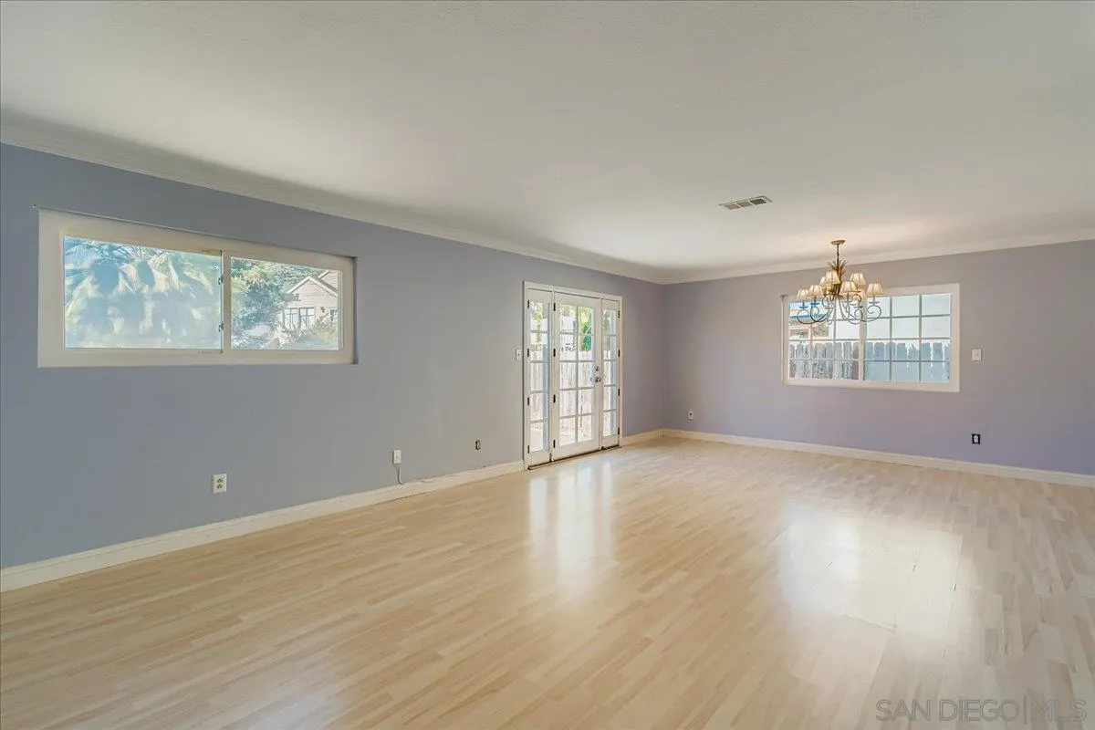 3245 Valley Street Carlsbad, CA 92008 - Photo 6 of 30 a view of an empty room with wooden floor and a window