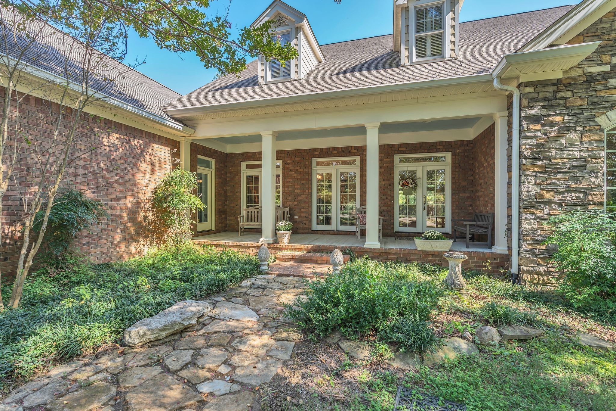 94 Oak Shadow Drive Loretto, TN 38469 - Photo 27 of 68 front view of a house with a large window and potted plants