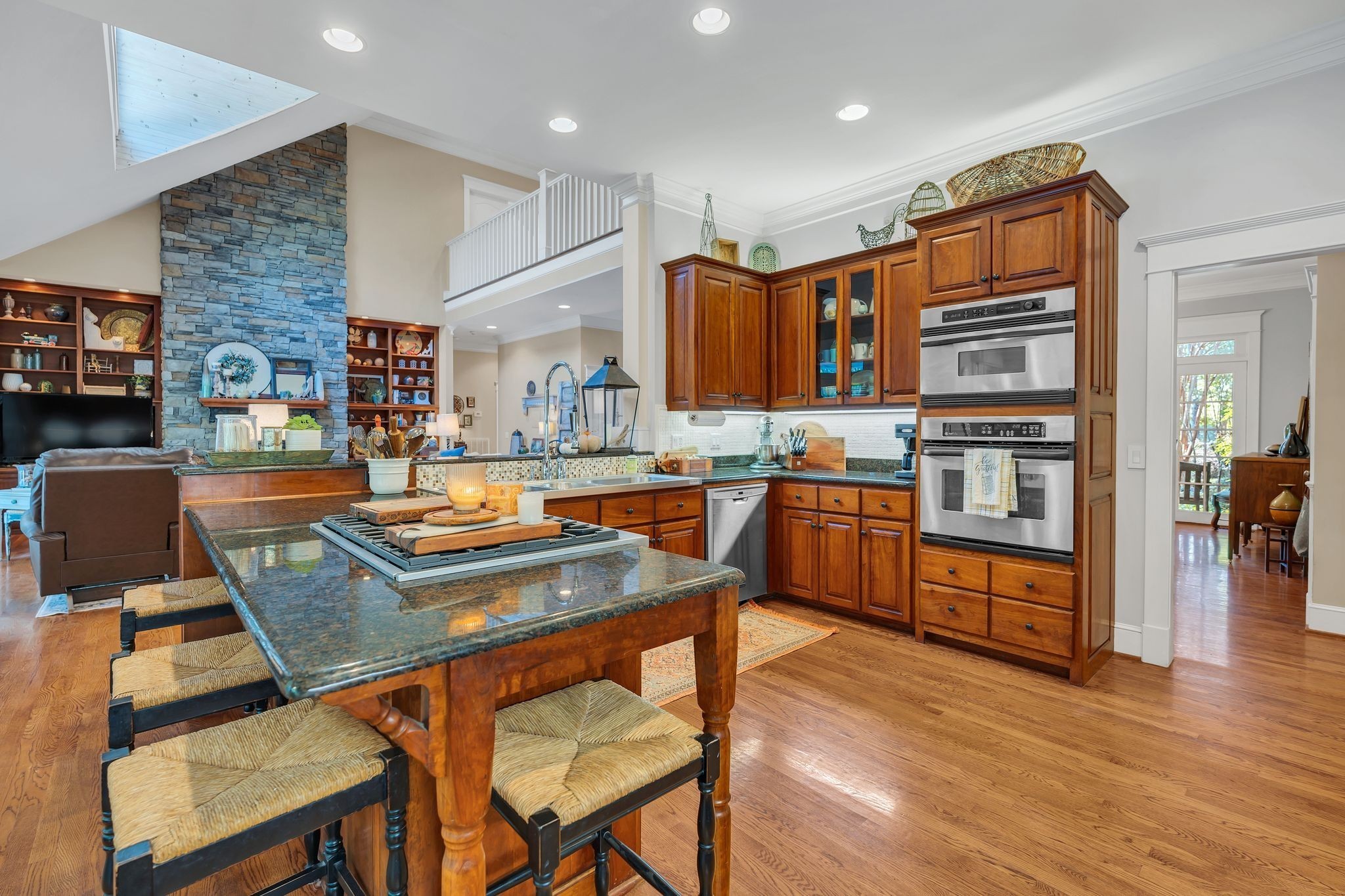 94 Oak Shadow Drive Loretto, TN 38469 - Photo 8 of 68 a kitchen with stainless steel appliances granite countertop a stove top oven a sink a dining table and chairs with wooden floor