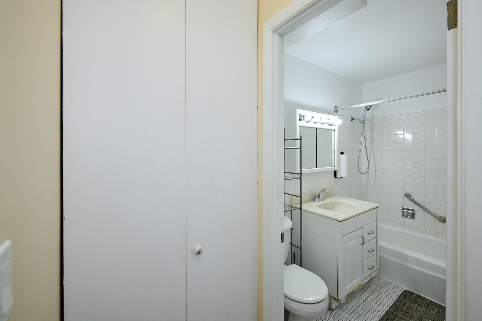 8541 Lotus Avenue, Unit 712 Skokie, IL 60077 - Photo 19 of 24 a bathroom with a granite countertop toilet a sink and a mirror