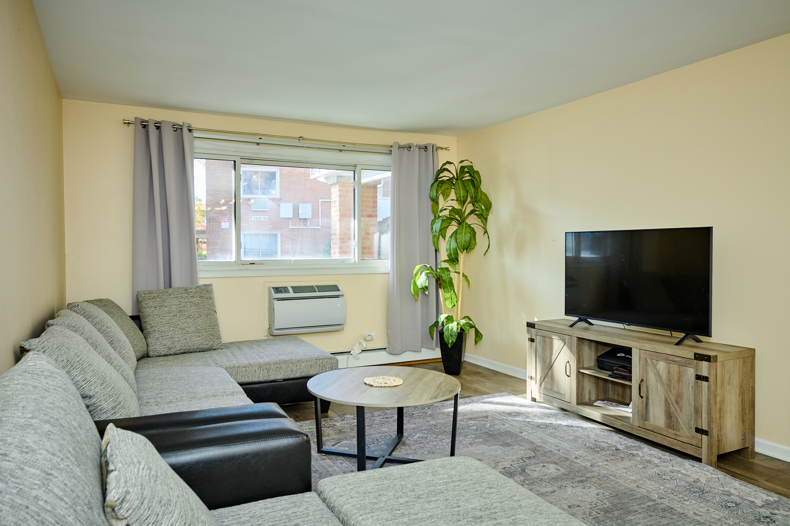 8541 Lotus Avenue, Unit 712 Skokie, IL 60077 - Photo 7 of 24 a living room with furniture and a flat screen tv