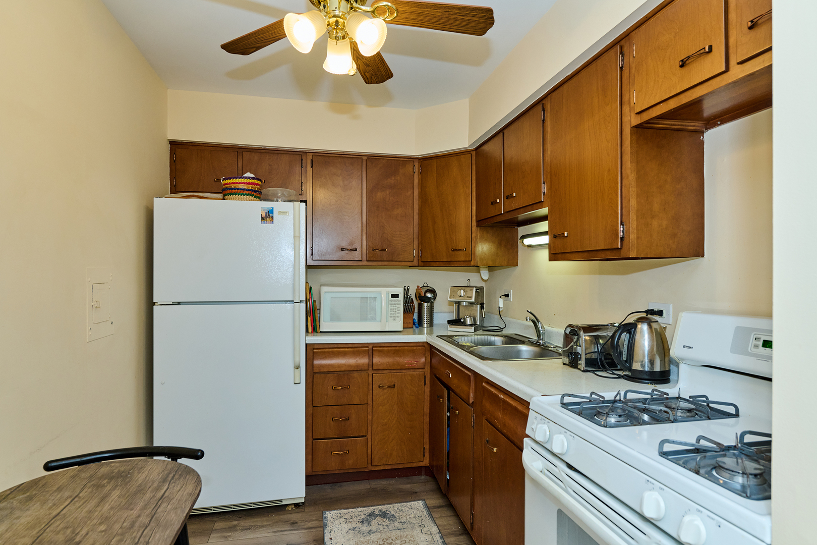 8541 Lotus Avenue, Unit 712 Skokie, IL 60077 - Photo 10 of 24 a kitchen with a sink a refrigerator and cabinets