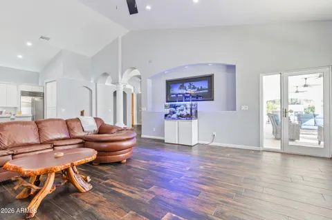 a living room with fireplace furniture and a wooden floor