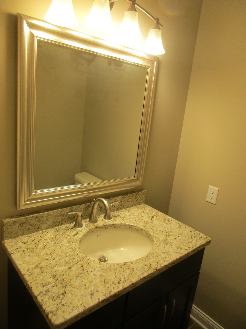 507 San Carlos Road Minooka, IL 60447 - Photo 12 of 48 a bathroom with a granite countertop sink and a mirror