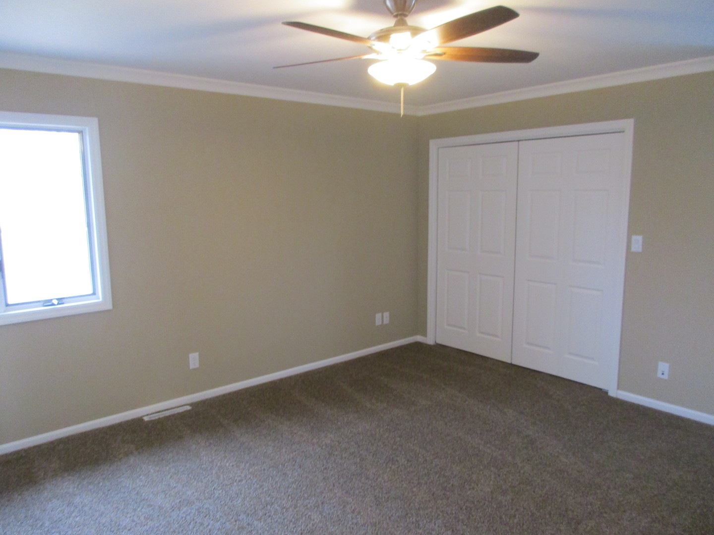 507 San Carlos Road Minooka, IL 60447 - Photo 15 of 48 an empty room with a window and a fan