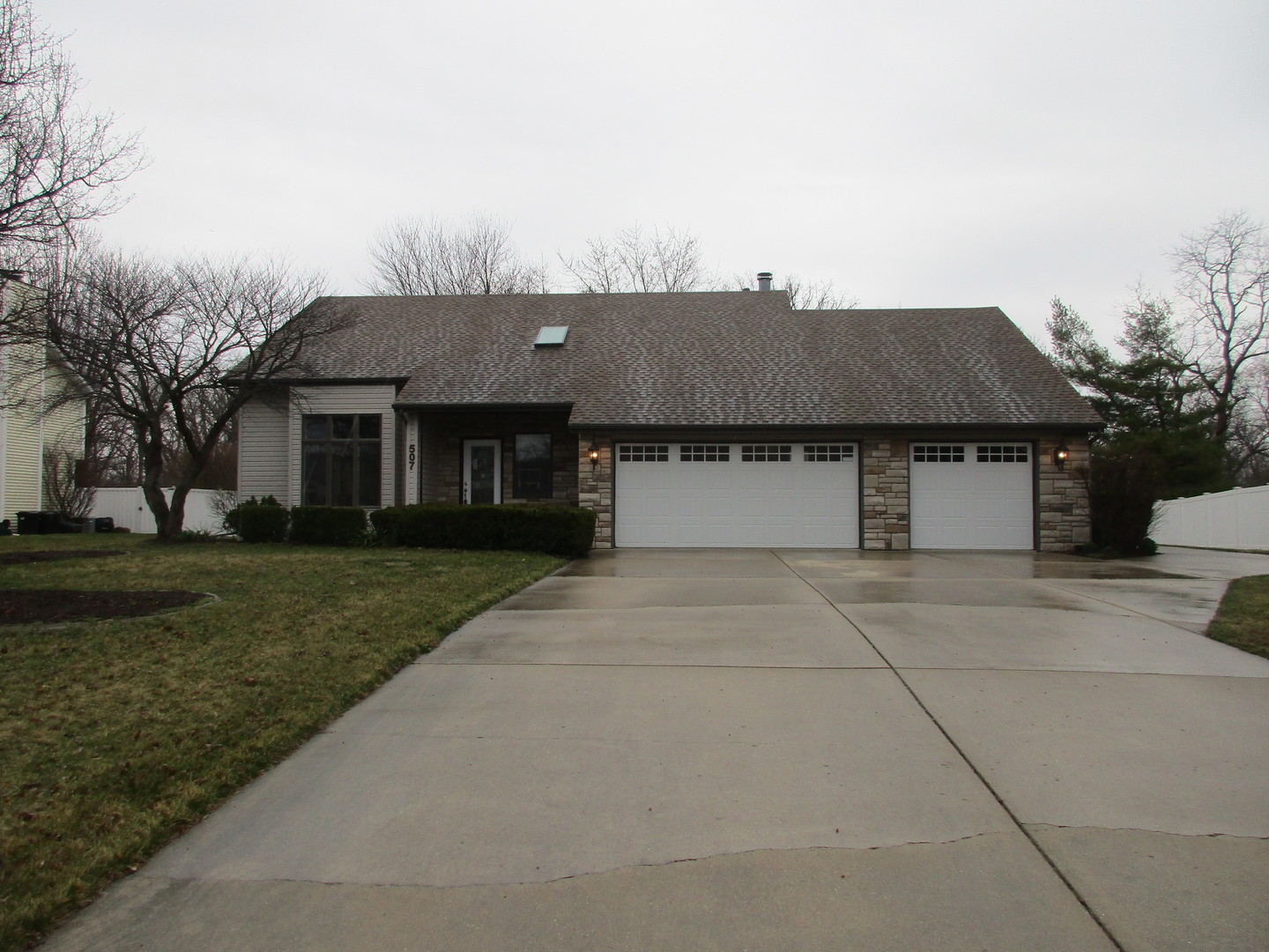 507 San Carlos Road Minooka, IL 60447 - Photo 3 of 48 a front view of a house with a garden and trees