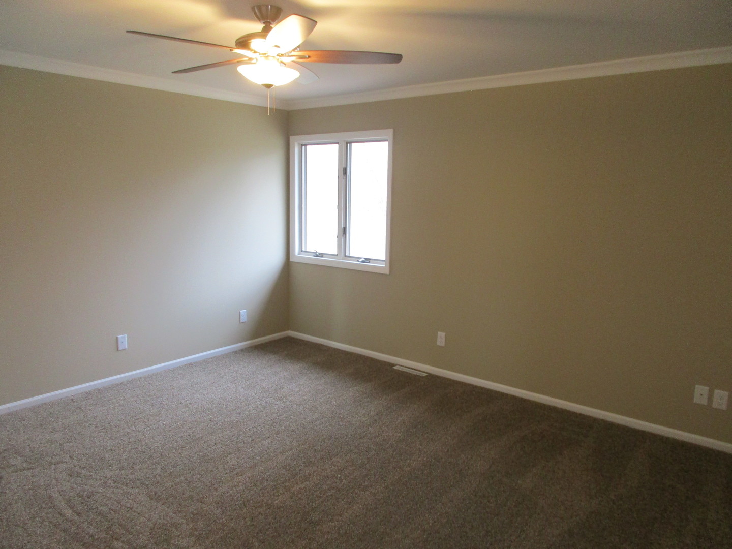 507 San Carlos Road Minooka, IL 60447 - Photo 24 of 48 an empty room with a window and a fan